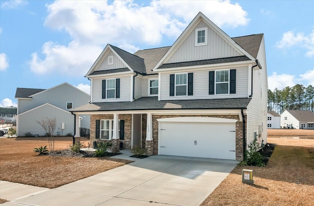 craftsman-style house with a garage, a front yard, and covered porch