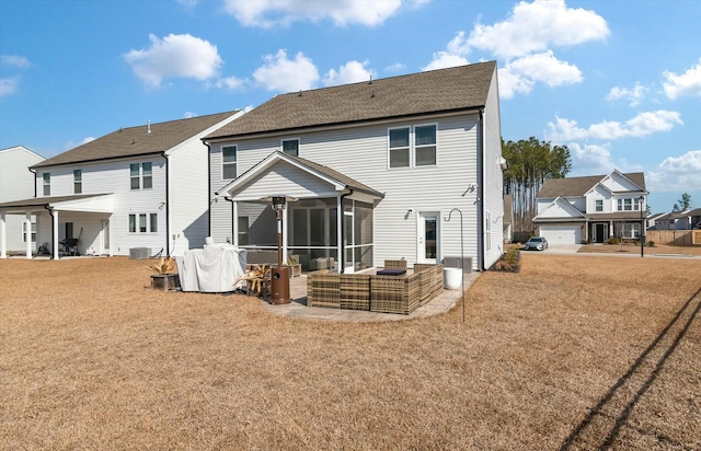 rear view of house featuring central AC unit, a sunroom, and a lawn