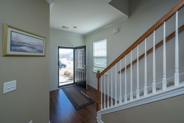 foyer entrance featuring baseboards, visible vents, stairs, hardwood / wood-style flooring, and crown molding