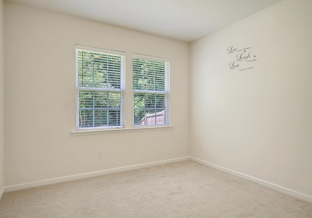 unfurnished room featuring baseboards and carpet floors