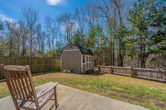 view of yard featuring a patio area, a fenced backyard, a storage unit, and an outdoor structure