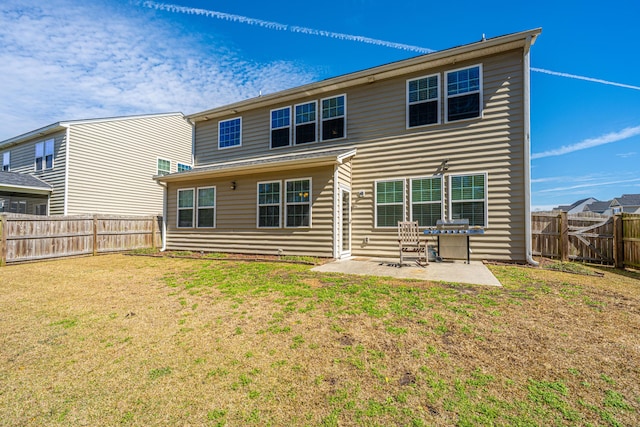 back of house featuring a yard, a fenced backyard, and a patio area