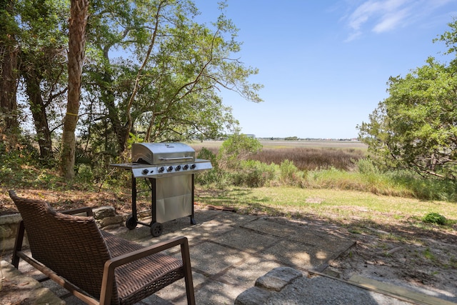 view of patio with grilling area and a rural view