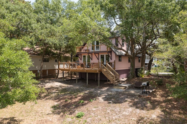 back of house featuring a wooden deck