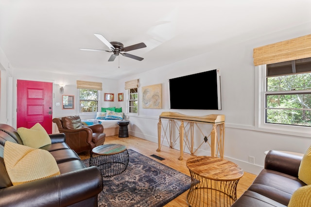 living room featuring hardwood / wood-style floors and ceiling fan