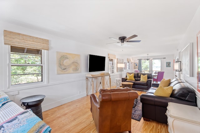 living room with ceiling fan and light hardwood / wood-style flooring