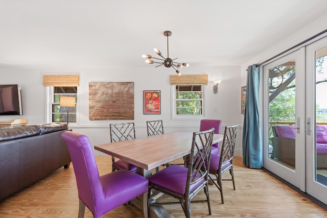 dining room with a notable chandelier and light wood-type flooring