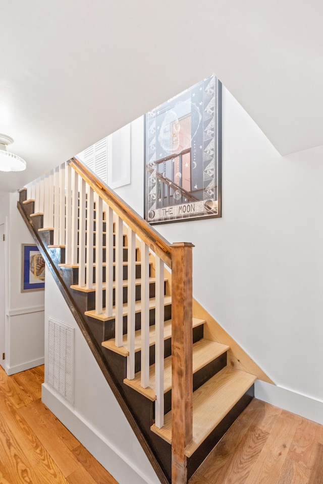 stairway with hardwood / wood-style flooring