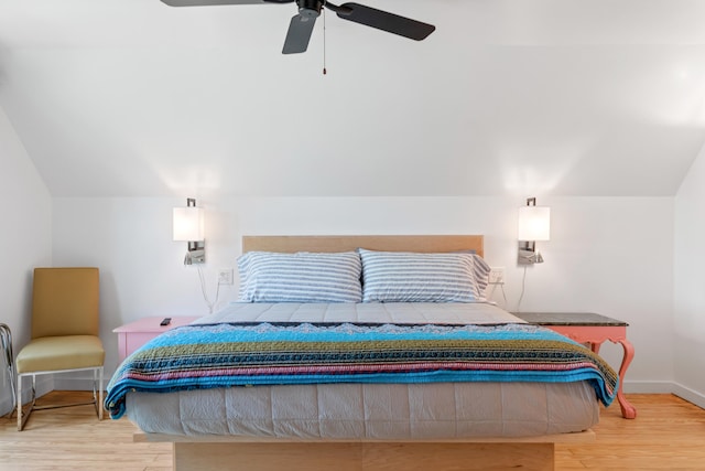 bedroom featuring ceiling fan, light hardwood / wood-style flooring, and vaulted ceiling