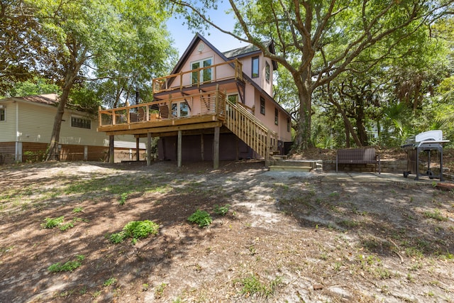 rear view of house with a wooden deck