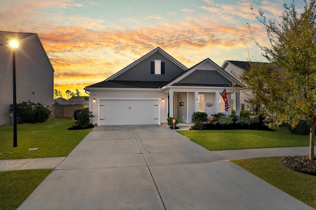 view of front facade with a garage and a lawn