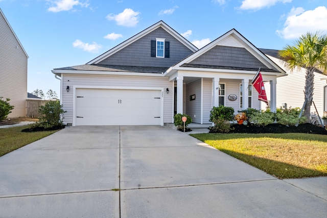 view of front of home with a front yard and a garage