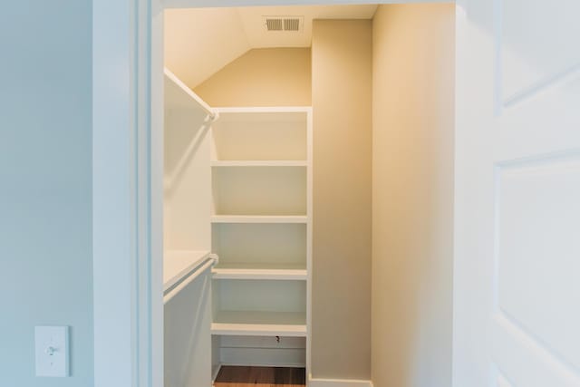 spacious closet featuring visible vents and wood finished floors