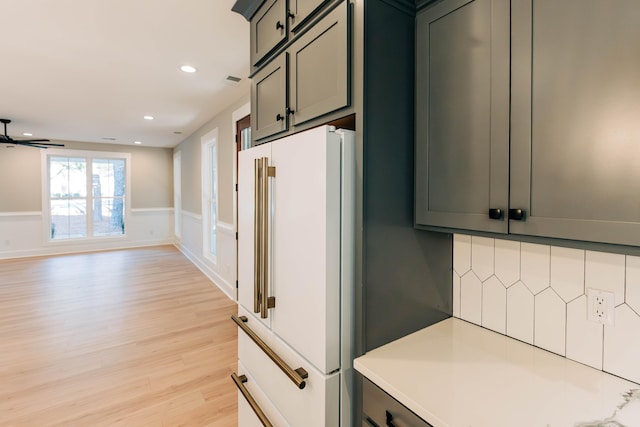 kitchen featuring light wood-style flooring, freestanding refrigerator, recessed lighting, light countertops, and ceiling fan