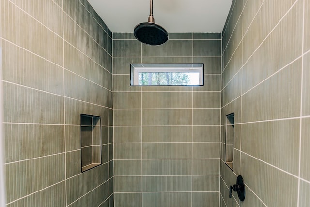 bathroom with a tile shower