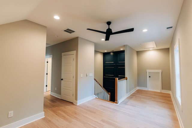 interior space featuring light wood-type flooring, visible vents, baseboards, and a ceiling fan