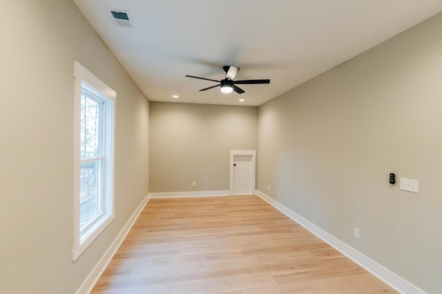 empty room with light wood finished floors, visible vents, baseboards, and ceiling fan