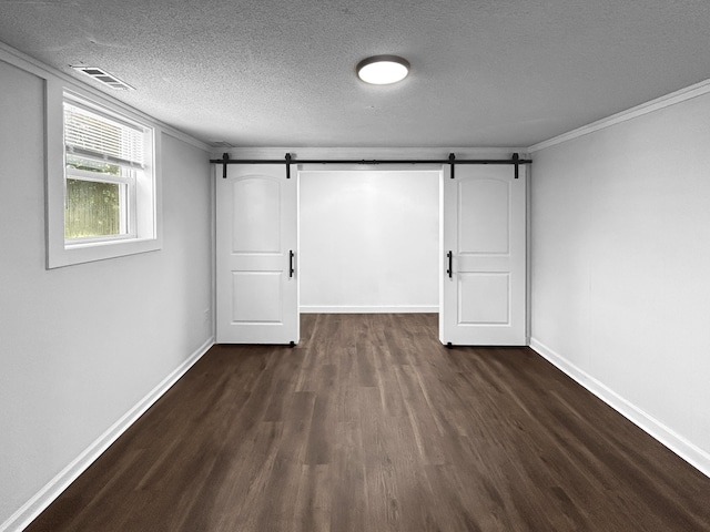 1481 Woodview Ln, Charleston, SC 29412 - below grade area featuring a barn door, dark wood-style flooring, a textured ceiling, and crown molding