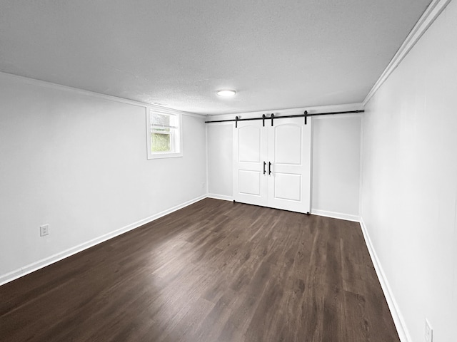 1481 Woodview Ln, Charleston, SC 29412 - below grade area featuring dark wood-type flooring, a barn door, a textured ceiling, and crown molding