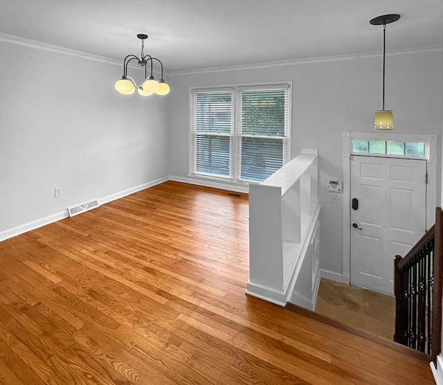 1481 Woodview Ln, Charleston, SC 29412 - entrance foyer featuring crown molding, plenty of natural light, a chandelier, and wood finished floors