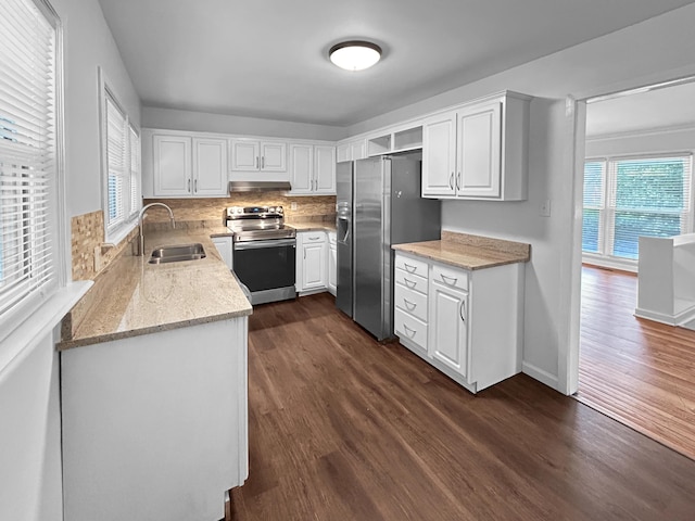1481 Woodview Ln, Charleston, SC 29412 - kitchen with stainless steel appliances, under cabinet range hood, dark wood finished floors, and white cabinets