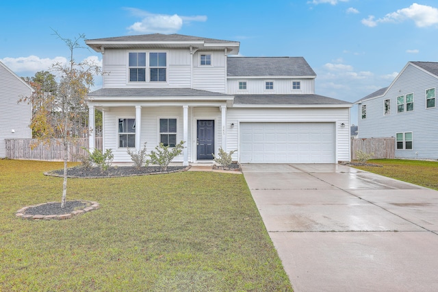 view of front of house featuring a garage and a front lawn