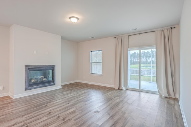 unfurnished living room with light hardwood / wood-style flooring