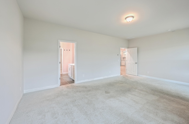 unfurnished room with light colored carpet