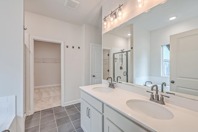 bathroom featuring shower with separate bathtub, vanity, and tile patterned floors