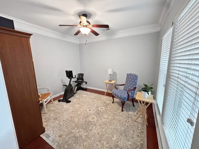 sitting room featuring wood-type flooring, ceiling fan, and ornamental molding