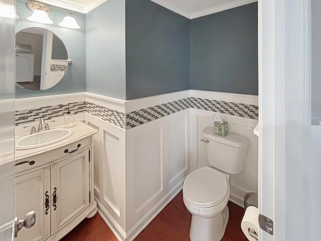 bathroom featuring vanity, toilet, and crown molding