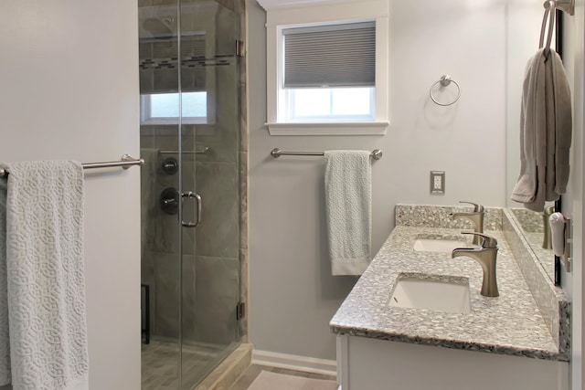 bathroom featuring vanity and a shower with door