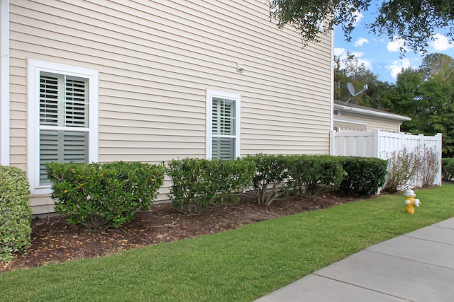 view of property exterior with a lawn