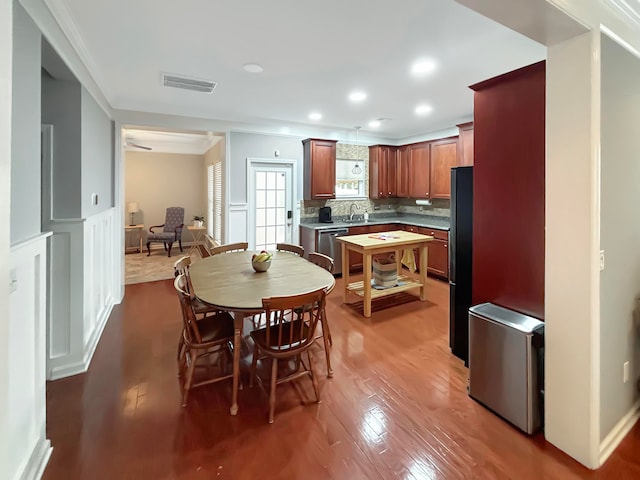 dining area with sink and wood-type flooring