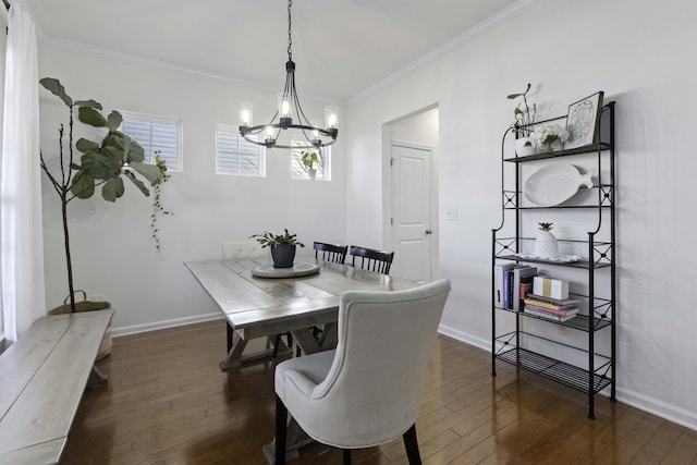 dining space with a notable chandelier, wood-type flooring, baseboards, and crown molding