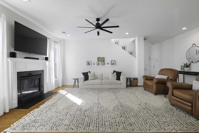 living room featuring ceiling fan, recessed lighting, a fireplace, wood finished floors, and visible vents