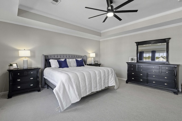 bedroom with light carpet, baseboards, visible vents, a raised ceiling, and ornamental molding