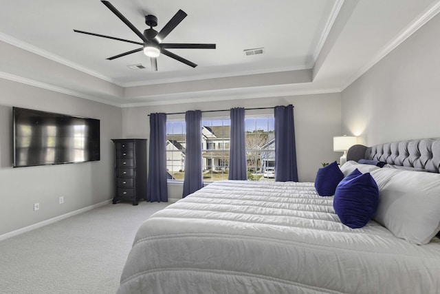 bedroom with carpet, visible vents, a raised ceiling, and crown molding