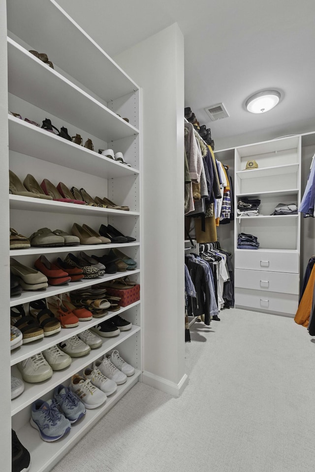 spacious closet featuring carpet flooring and visible vents