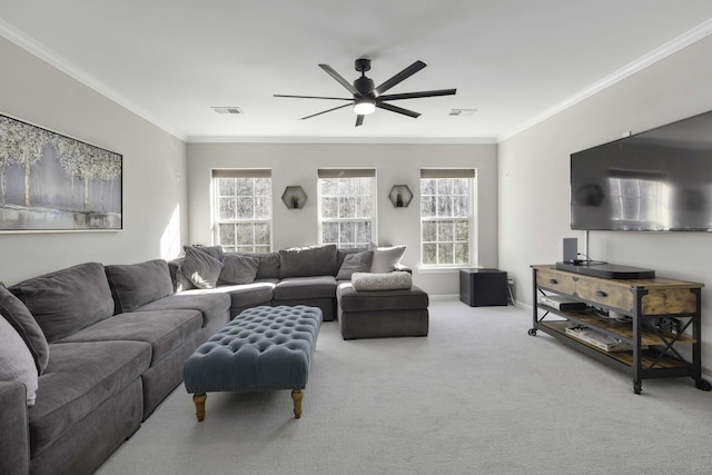 living room featuring ceiling fan, ornamental molding, carpet flooring, and visible vents