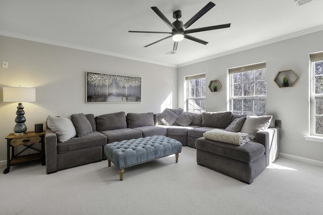 living area with ornamental molding, light carpet, ceiling fan, and baseboards