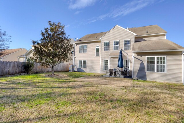 back of house with a lawn, a patio area, and fence