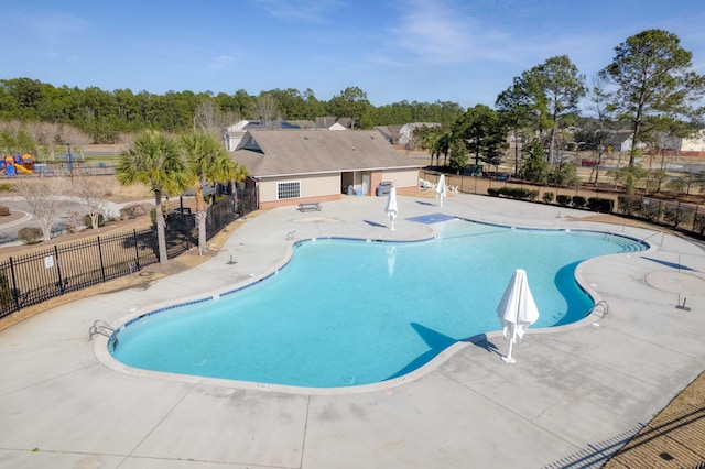 pool featuring fence and a patio