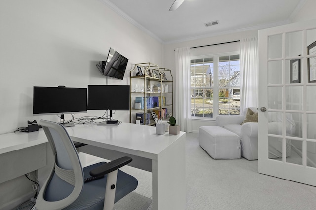 carpeted office space with ornamental molding, visible vents, and a ceiling fan