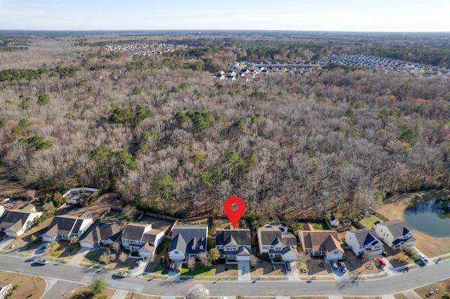 birds eye view of property with a residential view and a wooded view