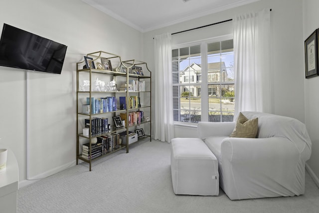 living area featuring baseboards, carpet floors, and crown molding