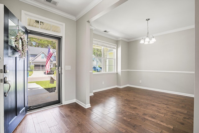 foyer entrance featuring a chandelier, plenty of natural light, wood-type flooring, and baseboards