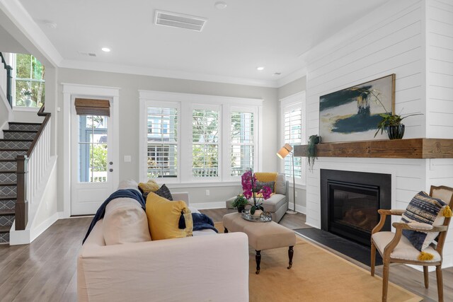 779 Forrest Dr, Charleston, SC 29492 - living room featuring ornamental molding, stairs, wood finished floors, a fireplace with flush hearth, and baseboards