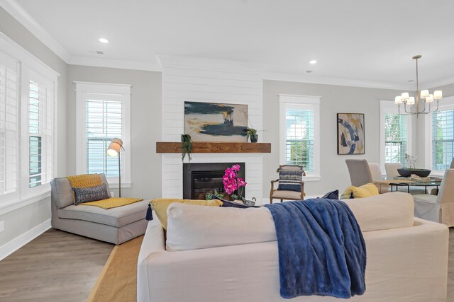 779 Forrest Dr, Charleston, SC 29492 - living room with a chandelier, wood finished floors, crown molding, a fireplace, and recessed lighting