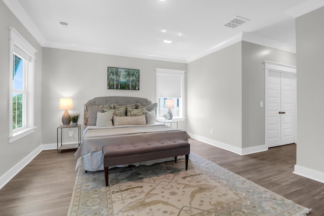 779 Forrest Dr, Charleston, SC 29492 - bedroom featuring multiple windows, crown molding, wood finished floors, and baseboards